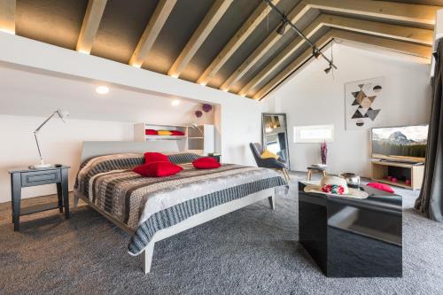 a bedroom with a large bed with red pillows at Residence Delta in Cavtat