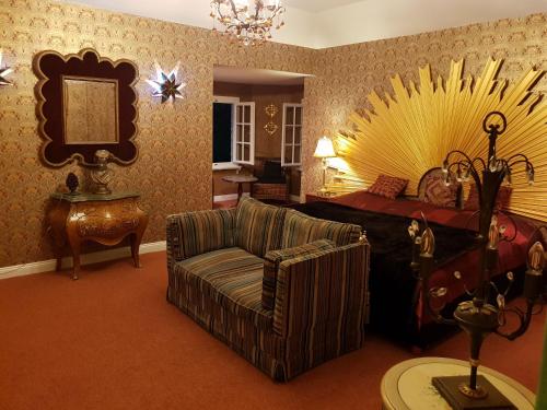a living room with a couch and a bed at Villa am Stechlin in Neuglobsow
