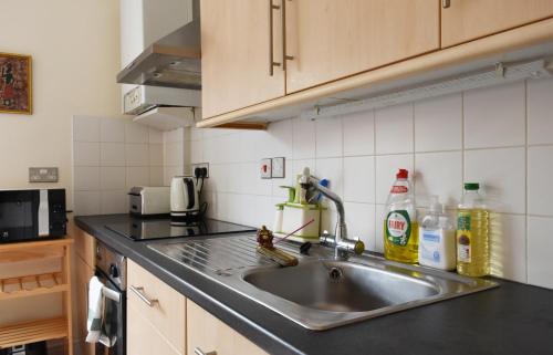 a kitchen with a sink and a counter top at Dale Street Apartments Suite in Leamington Spa