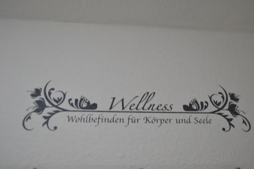 a wall sticker with the words wellness rendered for super surfer and stable at Haus Schimmelreiter in Greetsiel