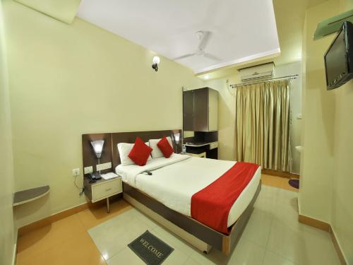 a hotel room with a bed and a television at Hotel New Sree Krishna Residency in Hyderabad