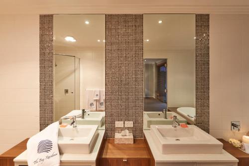 a bathroom with two sinks and a large mirror at The Bay Residence, Dunsborough WA in Quindalup