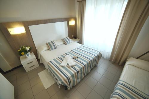 a hotel room with a bed with two plates on it at Hotel Villa Rosa in Sestri Levante
