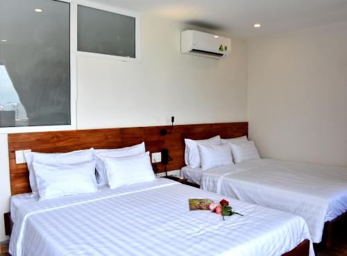 En eller flere senge i et værelse på Danang Beach Homestay