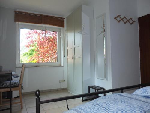 a bedroom with a bed and a window at Die Rochusberger in Bingen am Rhein