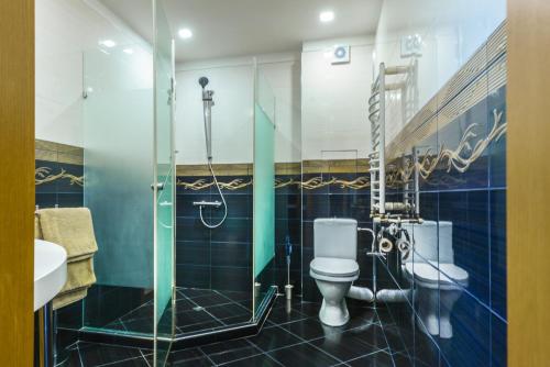 a bathroom with a toilet and a shower at The M Place in Sofia