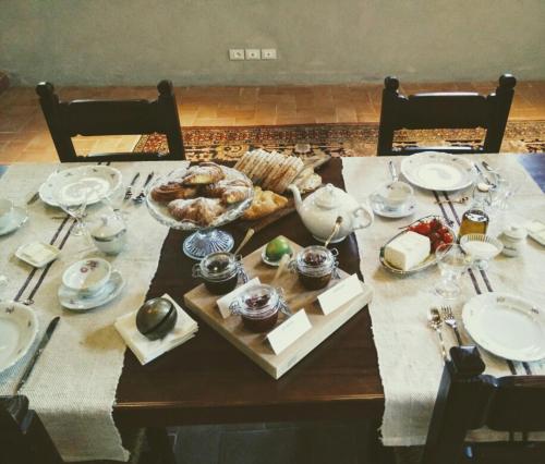 a wooden table topped with plates of food at Azienda Agricola Baccagnano in Brisighella