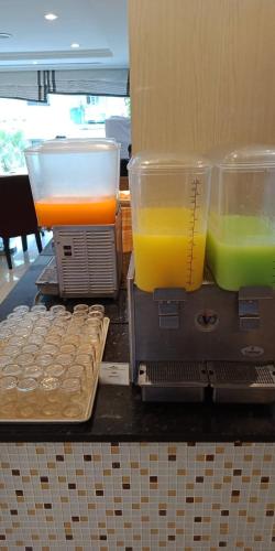 a table with two cups of juice and some food at The Maruay Garden Hotel in Bangkok