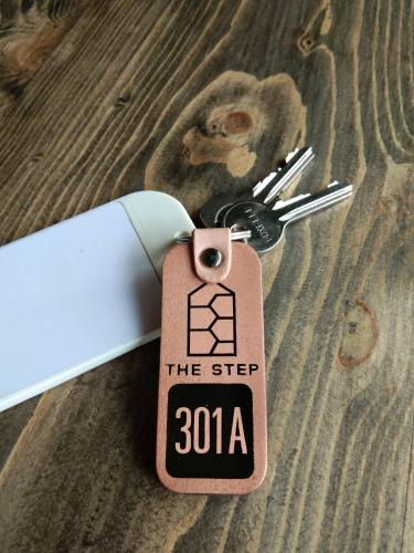 a key chain with a tag that says the step at The Step Chiang Mai in Chiang Mai