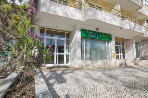a building with a sign on the front of it at Hotel Peregrinos de Fatima by Umbral in Fátima