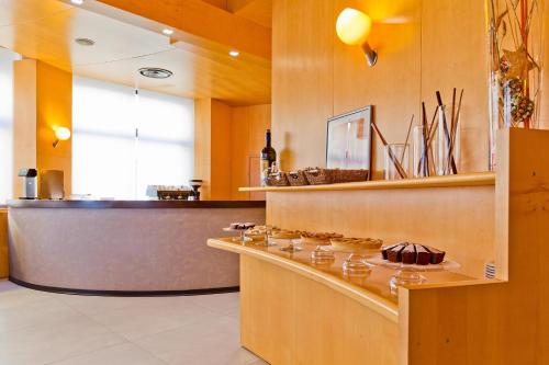 a kitchen with a counter with some food on it at Mediterranea Hotel & Convention Center in Salerno