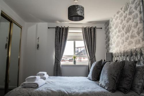 a bedroom with a bed in front of a window at No27 Ayr Beach - Coorie Doon Stays in Ayr