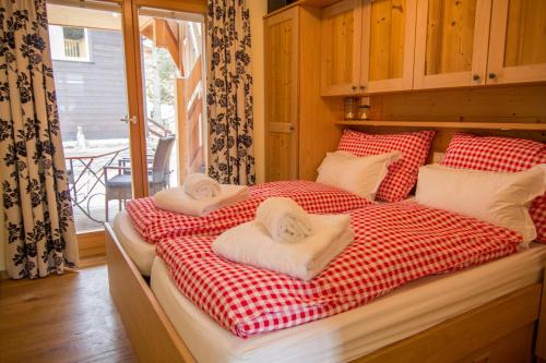 a bedroom with two beds with towels on them at Chalet Greta in Saas-Fee