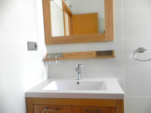 a bathroom with a sink and a mirror at Apt. Eros in Conil de la Frontera