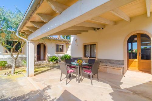 an outdoor patio with a table and chairs at Can Estelrich- Sant Blai in Campos