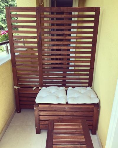 a bench with white pillows sitting on a balcony at Da Vinci Guesthouse in Varshets
