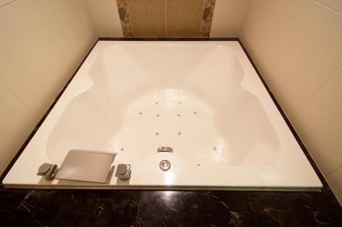 a bath tub with a laptop sitting in it at MRT Hotel in Taipei