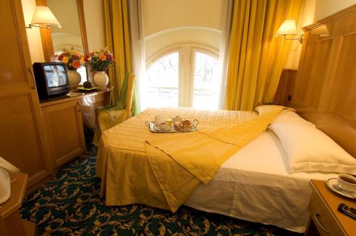 a hotel room with a bed and a window at Hotel Cinque Giornate in Milan
