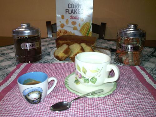 a table with two cups of coffee and a spoon at Casa Vacanze La Torretta in Sutri