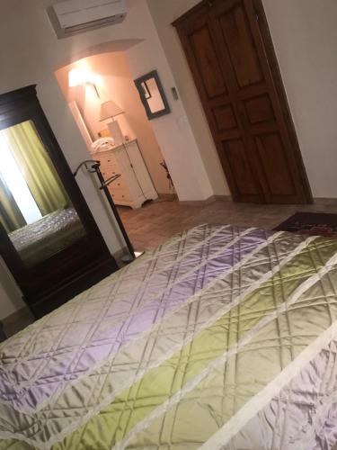 a large bed in a room with a door at A Balamata in Cervione