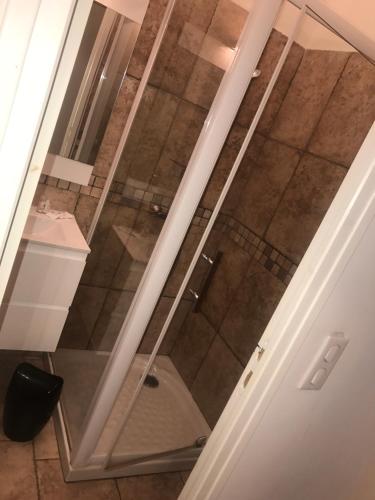 a glass shower door in a bathroom with a sink at A Balamata in Cervione