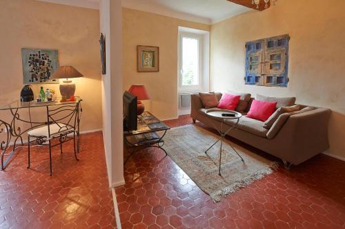 a living room with a couch and a table at La Grande Maison De Nans in Nans-les-Pins