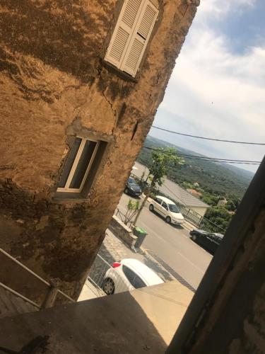 a view of a street from a window of a building at A Balamata in Cervione