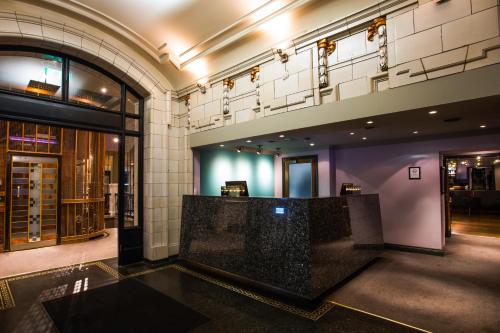 a lobby with a bar in a building at ABode Glasgow in Glasgow