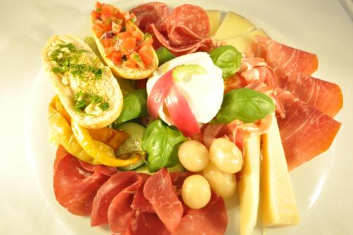 a plate of food with meat and vegetables on it at Grand Hotel Praha in Jičín
