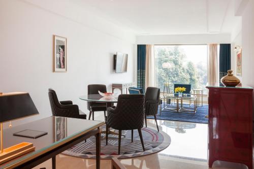 a living room with a table and chairs at The Oberoi New Delhi in New Delhi