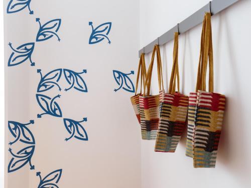 a row of chopsticks hanging on a wall at Heaven Inn Suites & Terrace in Évora