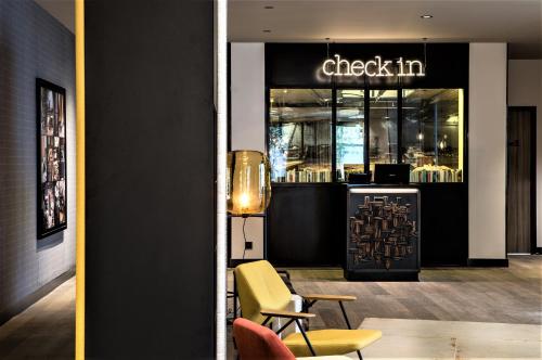 a restaurant with a sign that reads check in at L'Imprimerie Hôtel in Clichy