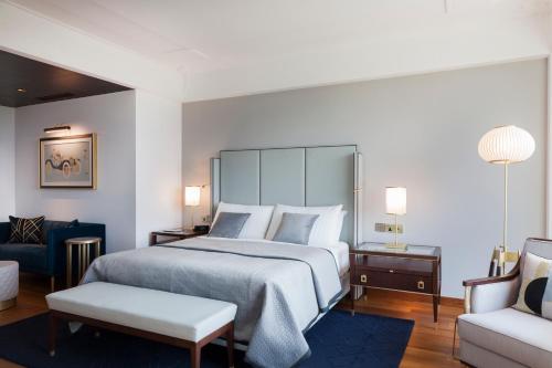 a bedroom with a large bed and a couch at The Oberoi New Delhi in New Delhi