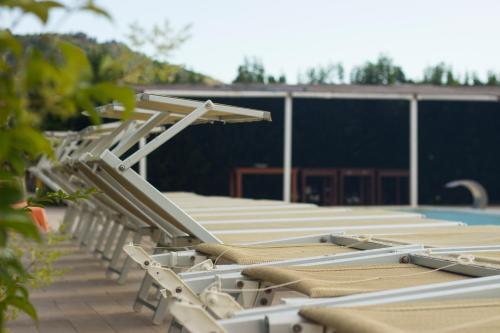 a row of chaise lounges sitting next to a swimming pool at Fontana La Pietra in Pisticci