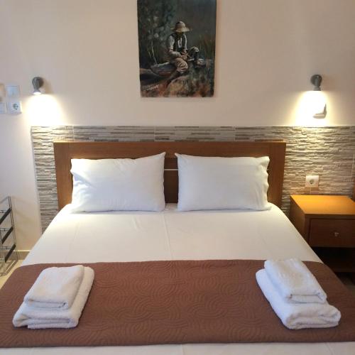 a bedroom with a bed with two towels on it at Villa Verano in Asprovalta