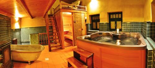 a large bathroom with a tub and a sink at Pension Imperial Spa in Jičín