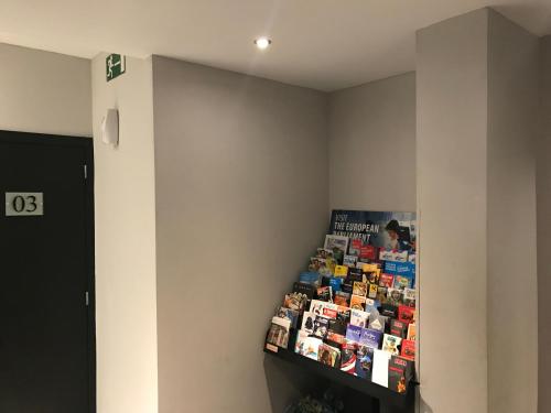 a room with a book shelf with books at Royal Hotel in Brussels