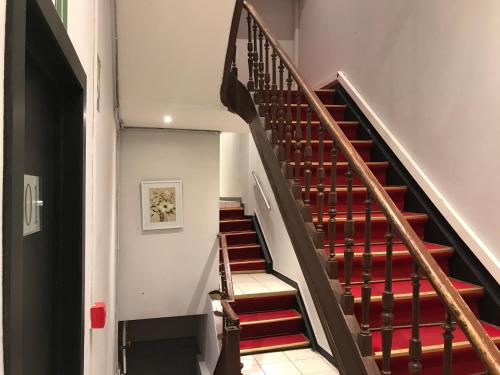 a staircase with red risers in a building at Royal Hotel in Brussels