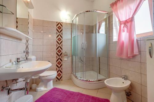 a bathroom with a shower and a sink and a toilet at Star in Mali Lošinj