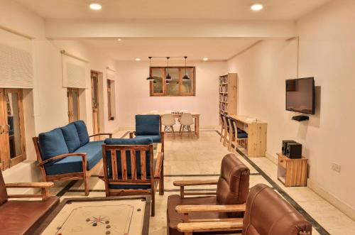 a living room filled with furniture and a tv at Ree Hostel in Leh