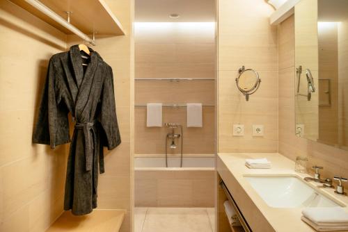 a bathroom with a robe hanging on a wall at Townhouse Dresden in Dresden