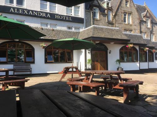 a group of picnic tables in front of a hotel at Alexandra Hotel in Fort William