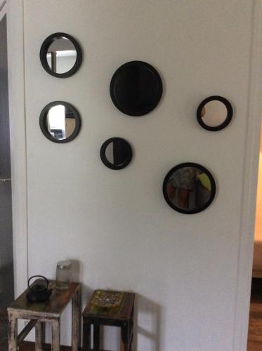 a wall with round mirrors on a white wall at belle la vie in La Plaine des Cafres