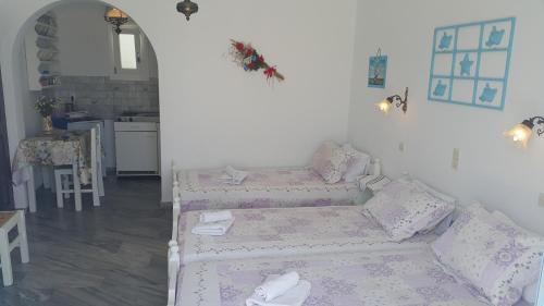 a living room with a couch and a table at Augusta Studios & Apartments in Naousa