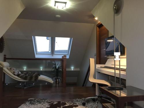 a living room with a piano and a chair at Waterfront House in Finstown