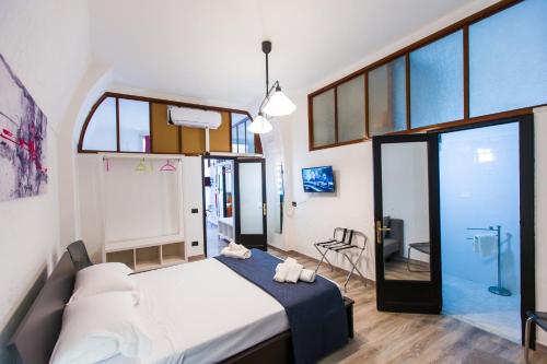 a bedroom with a large bed and a bathroom at B&B La Casetta in Cerignola