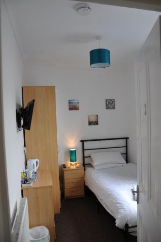 Postel nebo postele na pokoji v ubytování Victoria Villa Guesthouse