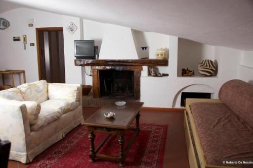 a living room with a couch and a fireplace at Tenuta Gaetano Spadaro in Capannori