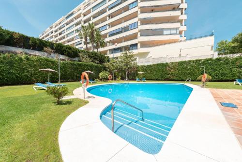 a swimming pool in front of a building at Apartamento Azul in Marbella