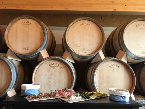 a bunch of barrels of wine on a table at Agriturismo Fattoria di Monticello in San Venanzo